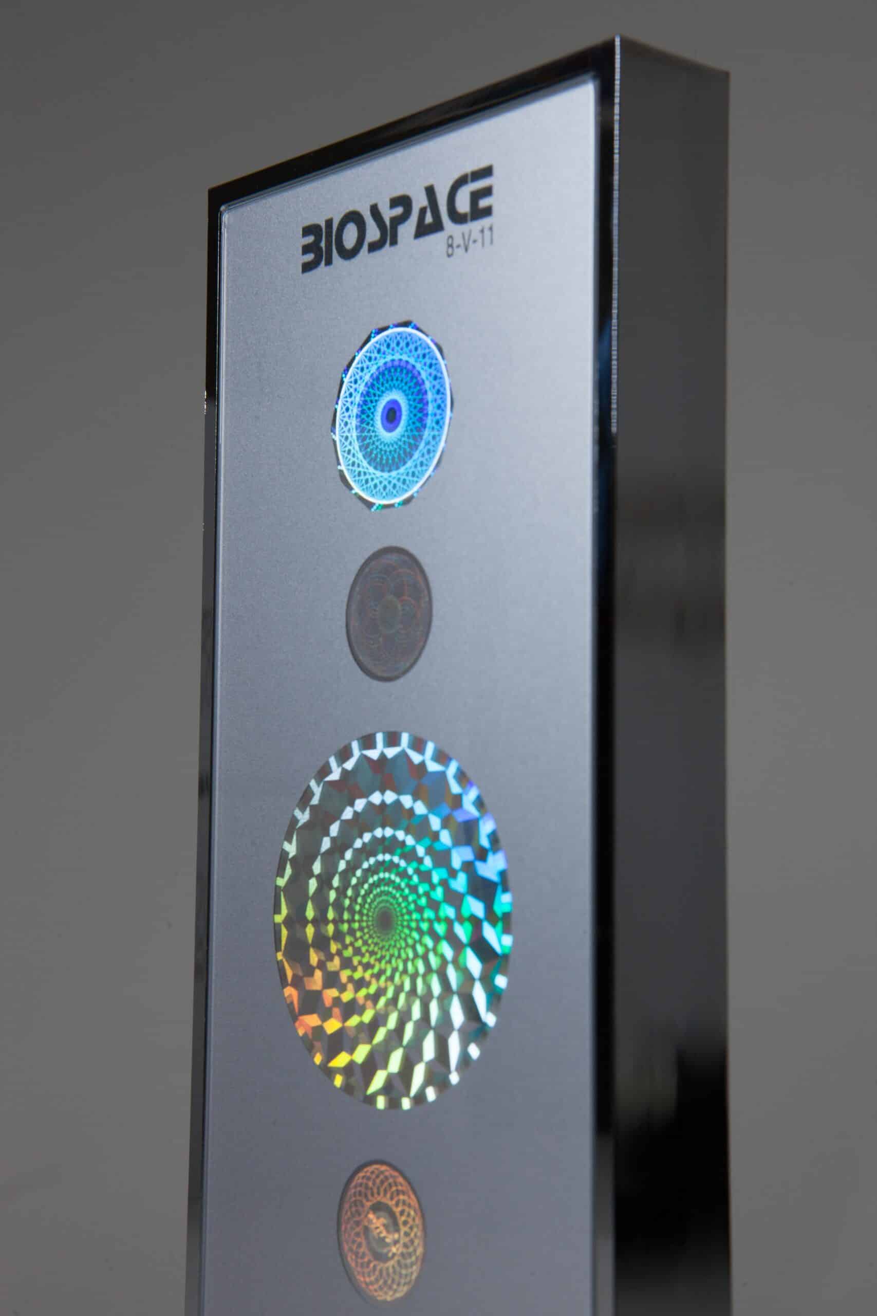BioSpace 8V11 Diamond display unit featuring three colored circular patterns. The top circle has a blue design, the middle is a solid gray, and the bottom showcases a vibrant multi-colored spiral, all on a sleek silver surface with a modern design.