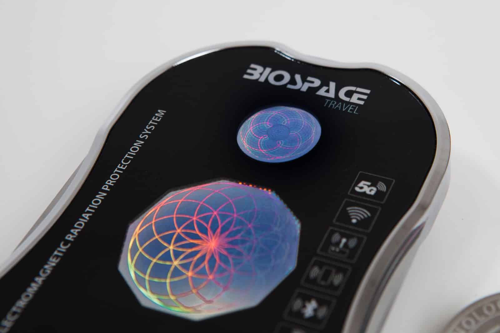 BioSpace Travel Diamond electromagnetic radiation protection system, featuring a glossy black surface and an iridescent geometric design, designed to reduce 5G radiation exposure. The product emphasizes modern technology and sustainability.