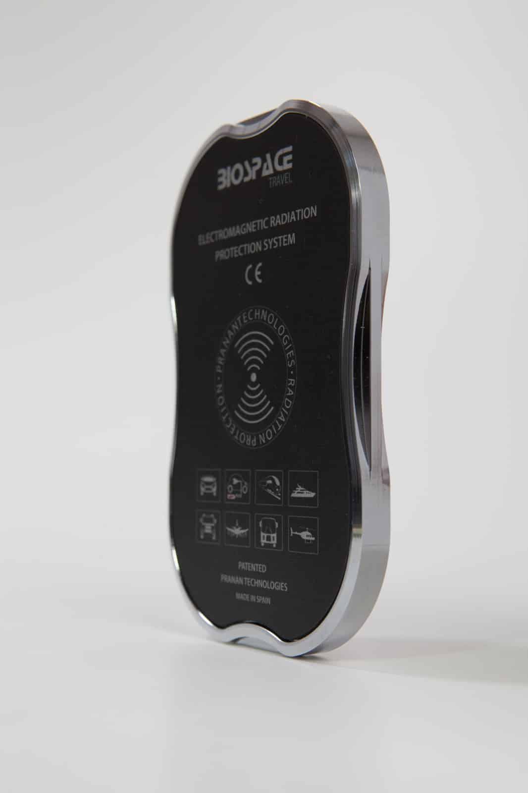 BioSpace Travel Diamond is an electromagnetic radiation protection device, featuring a sleek design with a black front and clear edges. It includes certification markings and is designed to minimize exposure to electromagnetic fields.