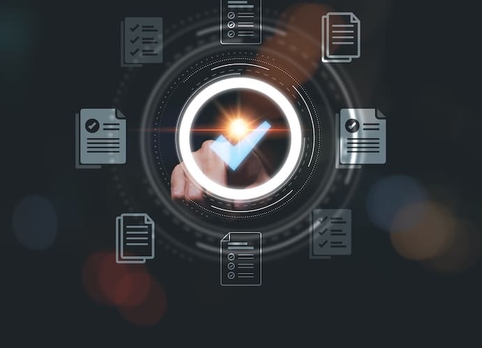 A hand touching a glowing circular checkmark icon, surrounded by multiple document icons. The background is dark with soft, blurred light effects, emphasizing the central checkmark and creating a digital interface appearance.
