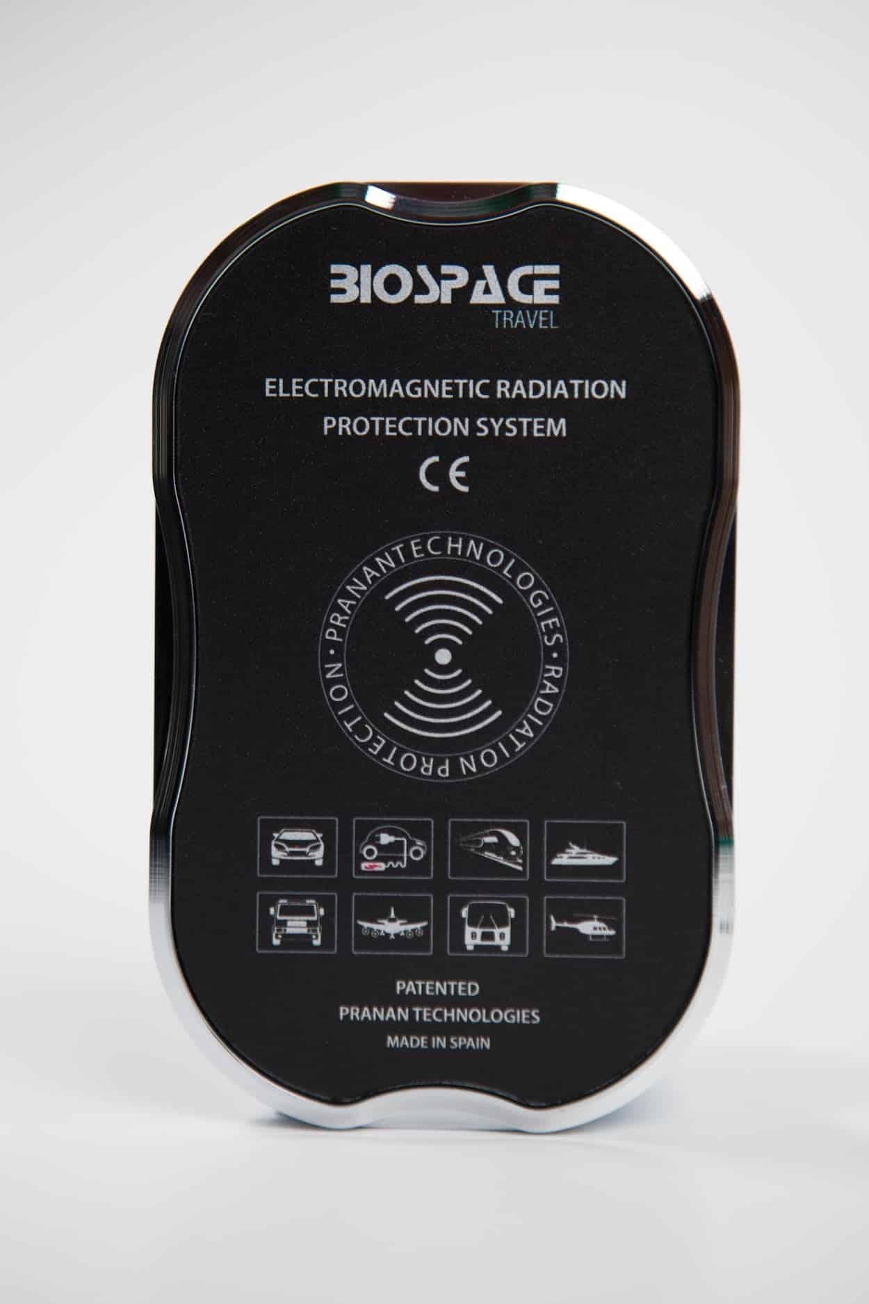 BioSpace Travel Diamond is an electromagnetic radiation protection system featuring a glossy black and silver finish. It includes symbols indicating protection features, and is made in Spain by Pranan Technologies.