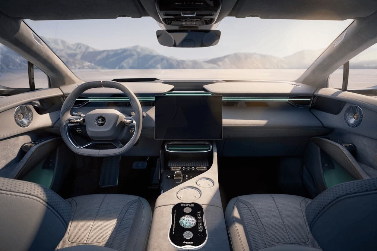 BioSpace Travel Diamond interior showcasing a sleek dashboard with a large central display, modern steering wheel, and soft grey upholstery, all highlighted by ambient lighting. The panoramic view reveals a mountainous landscape in background.