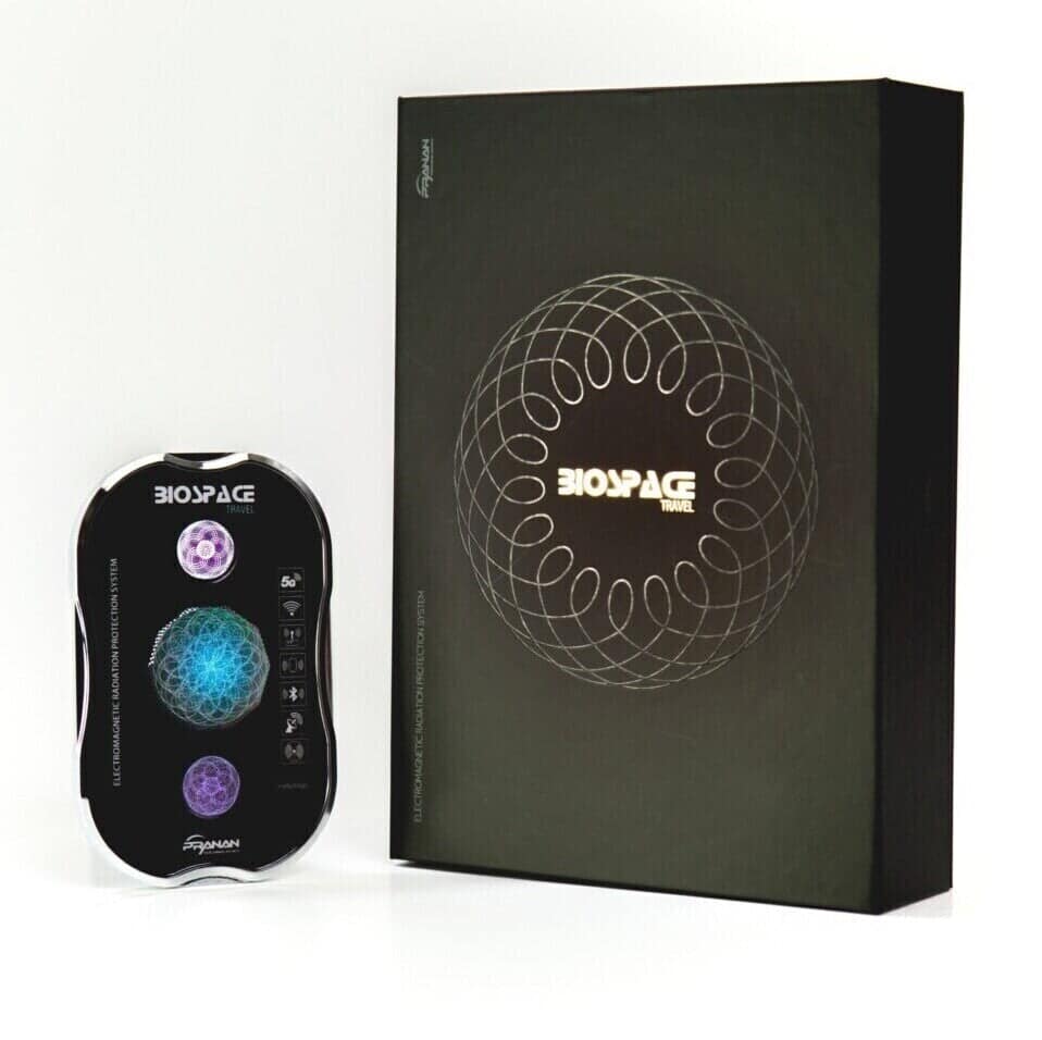 BioSpace Travel Diamond device shown alongside its packaging, featuring a black design with circular graphics. The device has buttons on one side and displays a blue and purple light pattern, indicating functionality.