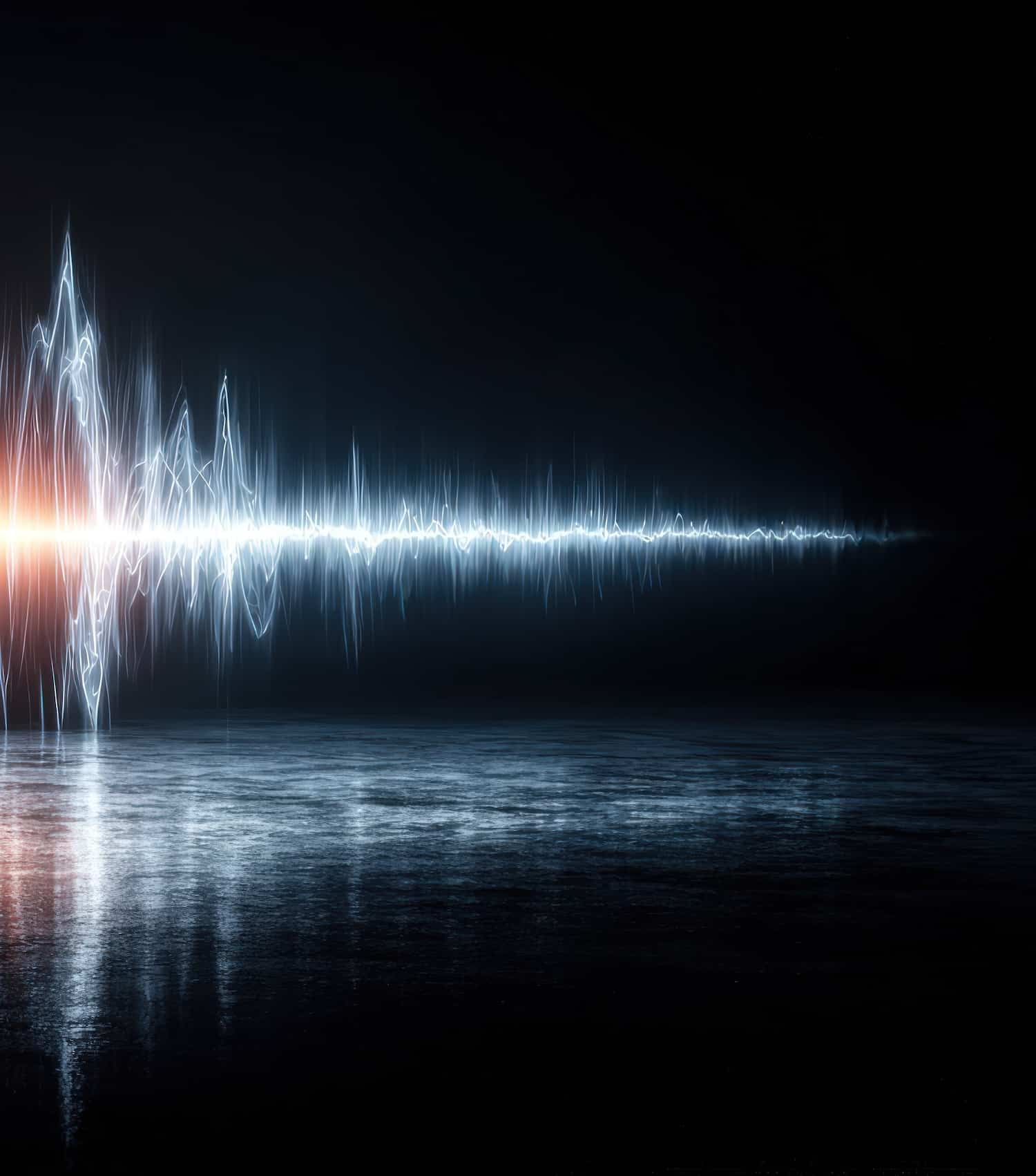 An abstract representation of sound waves, depicted as jagged lines in blue and white on a dark background. A section in the center glows orange, reflecting off a smooth, glass-like surface, creating a futuristic visual effect.